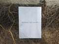"Arambol Fish Market" zine cover — handwritten title on white paper, resting on tangled grey fishing nets with golden rope