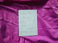 "A Love Letter to My Body I Wish I Read Growing Up" zine cover — handwritten title with trailing heart doodles on cream paper, on pink magenta fabric