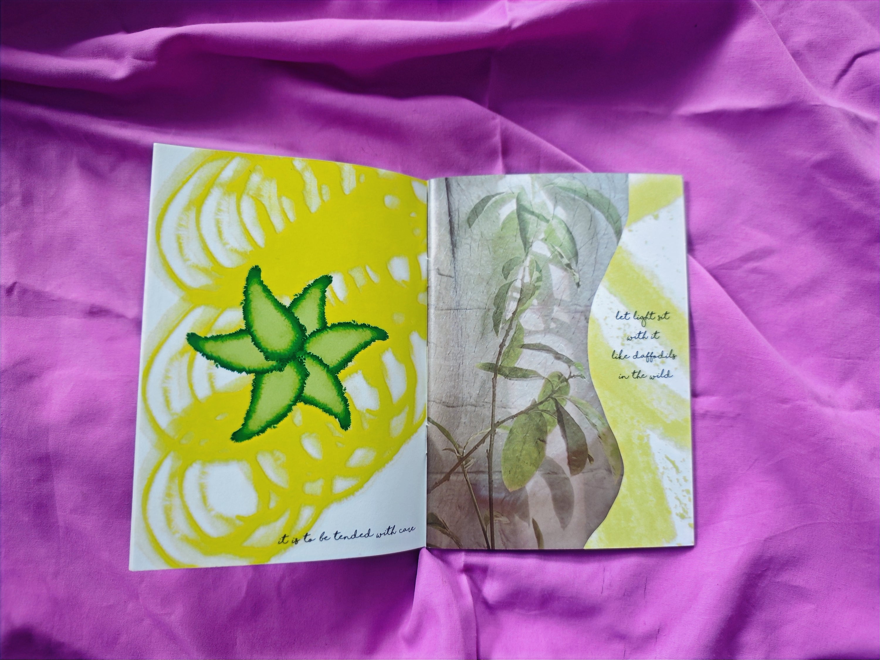 Open spread on pink fabric — bright yellow painting of starfruit with swirling lines reading "it is to be tended with care", alongside leaf photograph with golden curves and text "let light sit with it like daffodils in the wild"