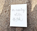 "An Evening With Star Fish" zine cover — handwritten title with small star drawing on white paper, resting on beach sand